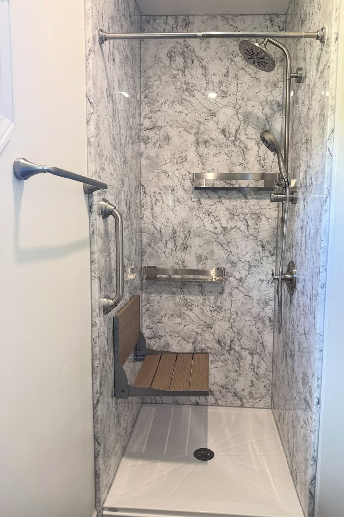 Marble-look walk-in shower with fold-down seat and grab bars, installed by EverBath in an Ohio home